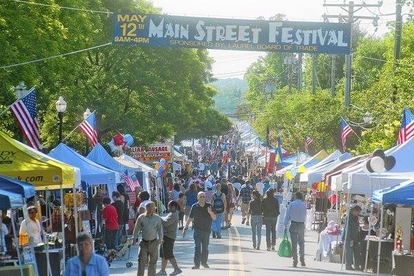 Children enjoying games and food at the Laurel Main Street Festival
